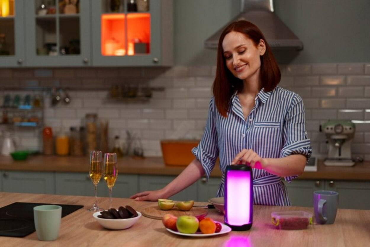 Woman with smart gadget in kitchen