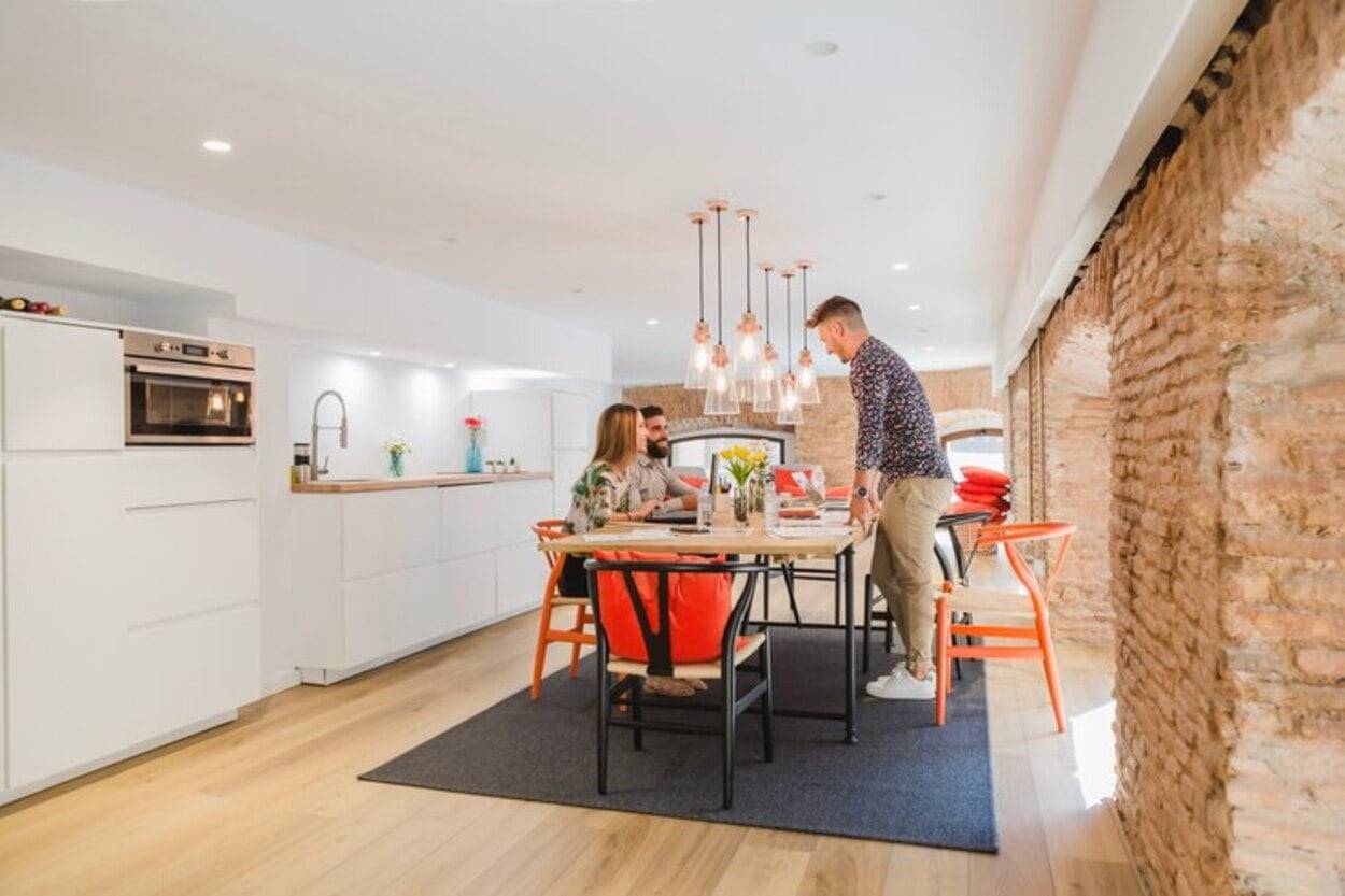 man-standing-talking-colleagues in kitchen